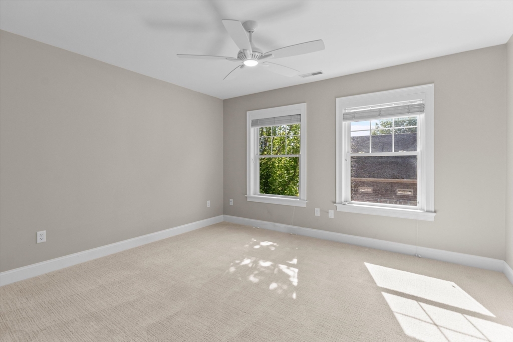 4 Emerald Way, Unit 4 Salisbury, MA 01952 - Photo 30 of 40 an empty room with windows and chandelier fan