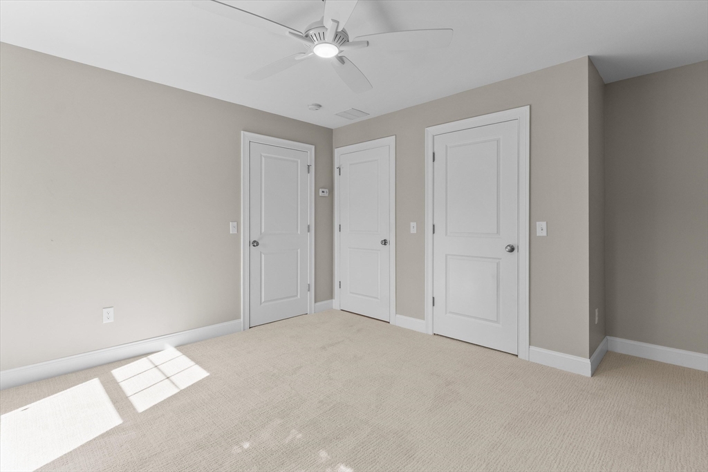 4 Emerald Way, Unit 4 Salisbury, MA 01952 - Photo 31 of 40 an empty room with a ceiling fan and a window