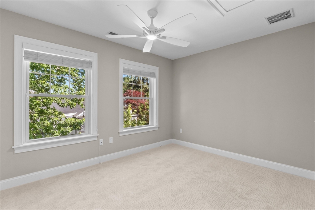 4 Emerald Way, Unit 4 Salisbury, MA 01952 - Photo 33 of 40 an empty room with a window and a fan