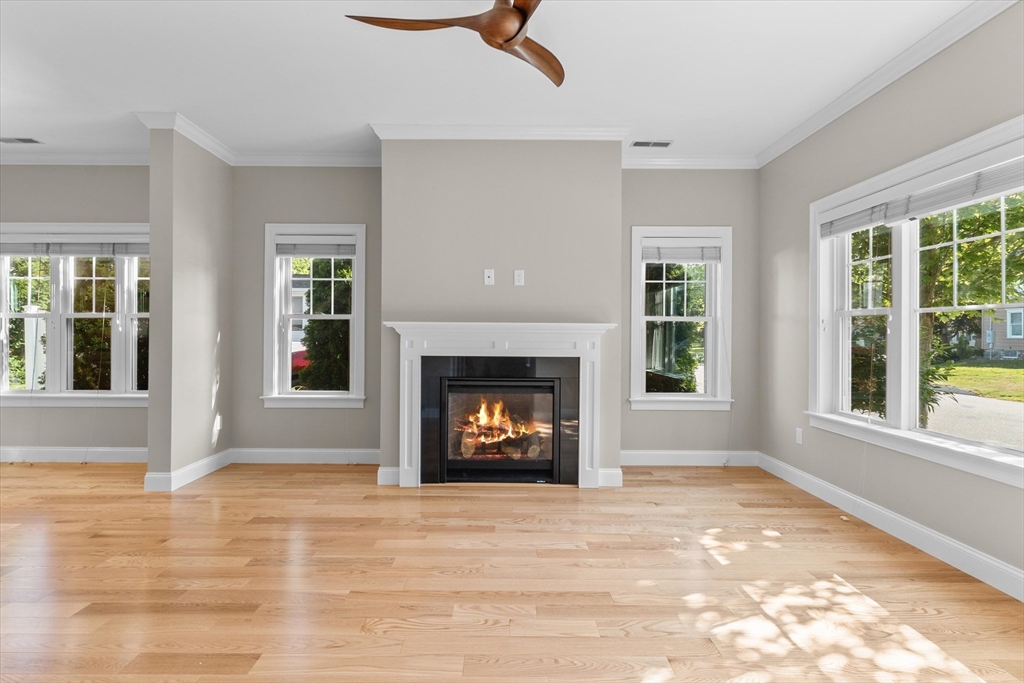 4 Emerald Way, Unit 4 Salisbury, MA 01952 - Photo 9 of 40 a view of an empty room with a fireplace and a window