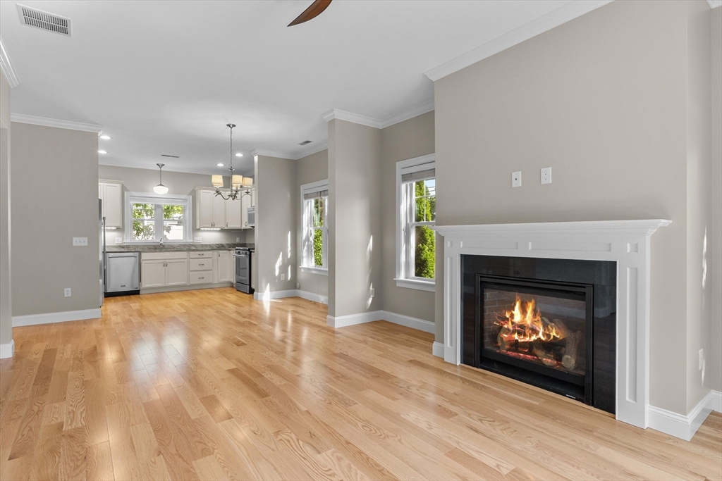 4 Emerald Way, Unit 4 Salisbury, MA 01952 - Photo 10 of 40 a open kitchen view with fireplace and wooden floor