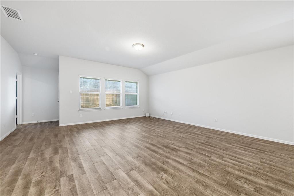 9308 Desertrock Road Fort Worth, TX 76131 - Photo 7 of 29 an empty room with wooden floor and windows