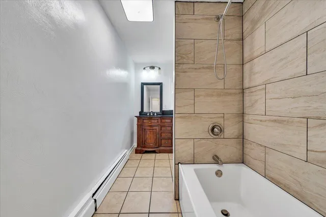 a bathroom with a bathtub and shower