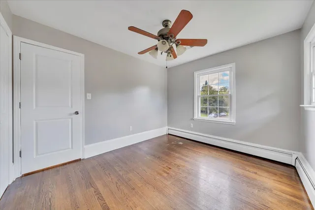 wooden floor in an empty room with a window