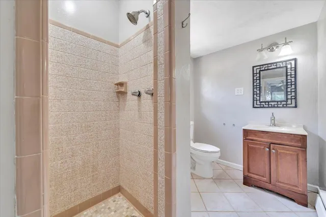 a bathroom with a toilet a sink and shower