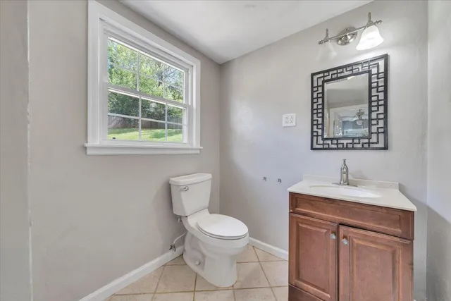 a bathroom with a toilet a sink and a mirror