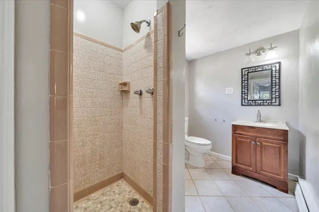 a bathroom with a toilet sink and shower