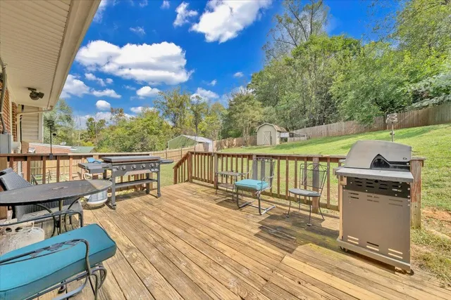 a view of a balcony with wooden floor and outdoor seating