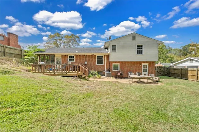 a view of a house with swimming pool and a yard