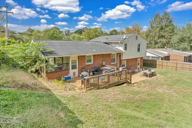 a view of a house with pool and sitting area