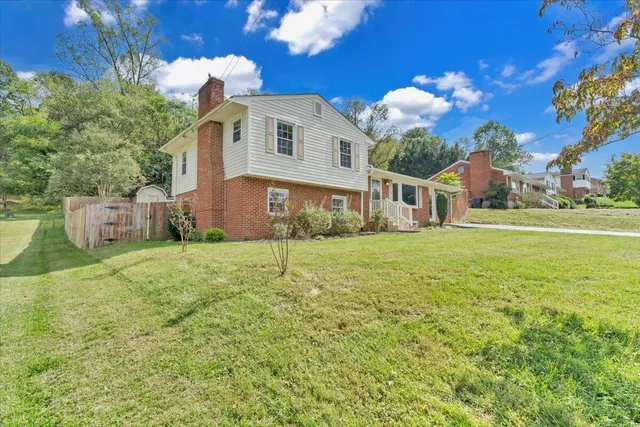 a front view of a house with a garden and yard