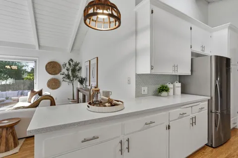 a view of a dining room with furniture and a chandelier