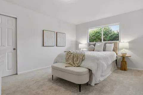 a bedroom with a bed and a lamp