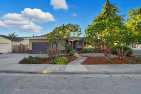 a front view of a house with a yard and a garage