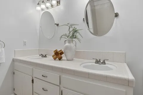 a bathroom with a sink a toilet and a mirror