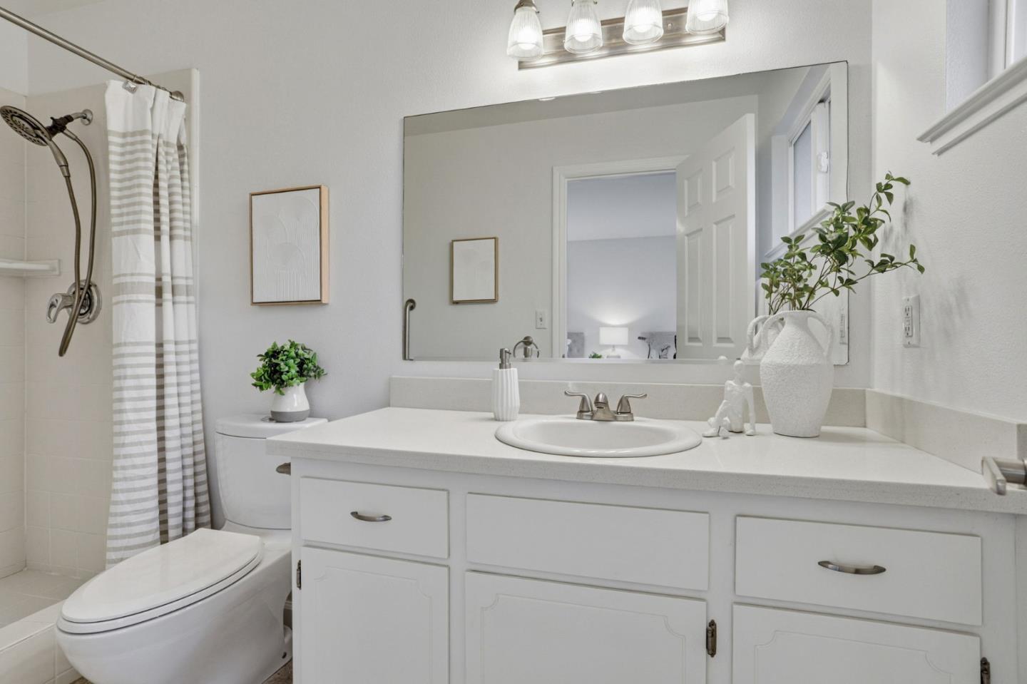 2119 Burr Court Santa Cruz, CA 95062 - Photo 30 of 38 a bathroom with a sink a toilet and a mirror