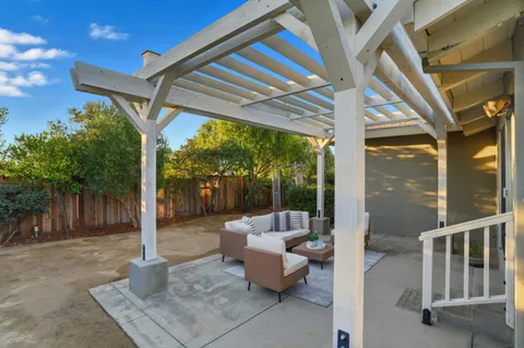a view of a patio with a table and chairs