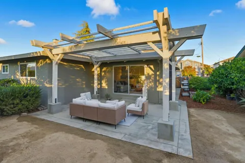 a view of a patio with table and chairs potted plants