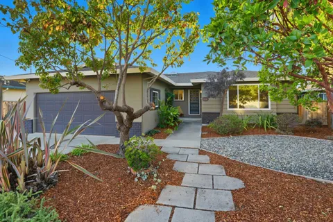 a view of a hallway with entryway wooden floor and front door