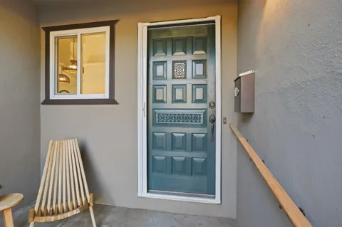 a living room with kitchen island furniture and a chandelier