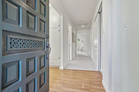 a living room with furniture and a lamp