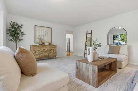 a kitchen with stainless steel appliances granite countertop a sink a stove and a refrigerator