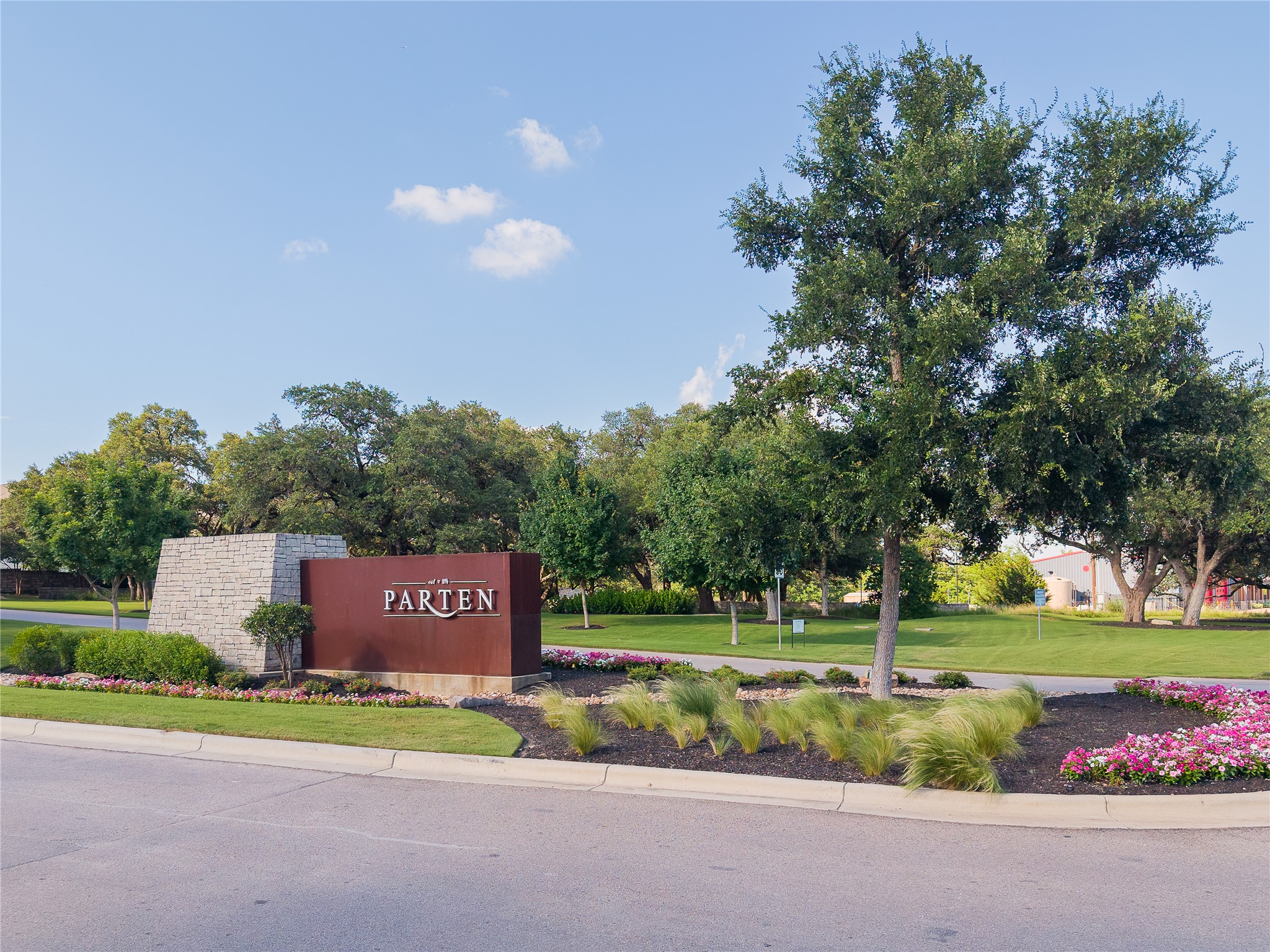 320 Old Stone Road Austin, TX 78737 - Photo 40 of 40 An inviting entrance with a stately sign, well-kept landscaping, and mature trees welcomes all who enter.