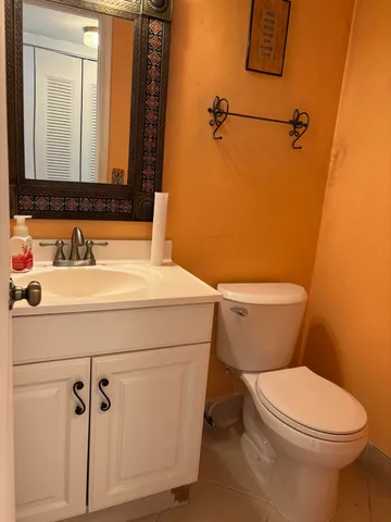 a bathroom with a sink mirror vanity and toilet