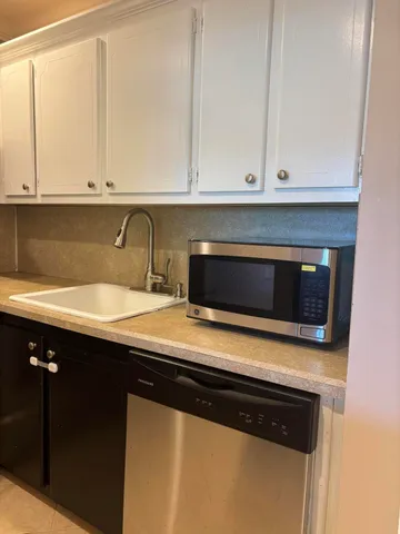 a kitchen with a sink and cabinets