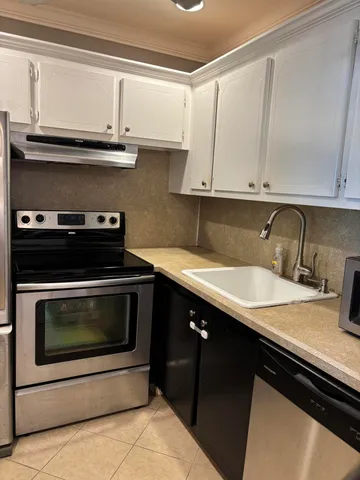 a kitchen with a sink stove and cabinets