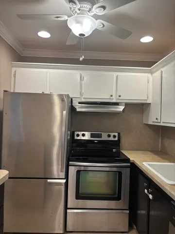 a stove top oven sitting inside of a kitchen