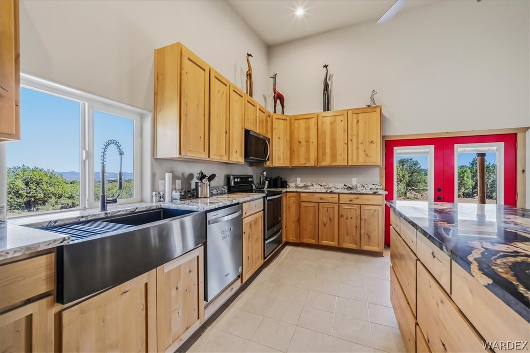 10374 East Happy Trails Road Kingman, AZ 86401 - Photo 19 of 68 a kitchen with stainless steel appliances granite countertop a sink and a stove