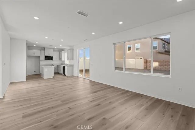 a view of a kitchen with a sink and a large window