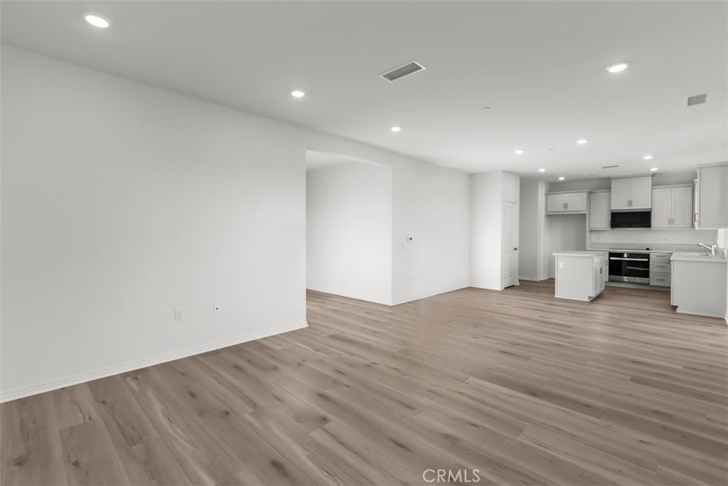 9667 Salamanca Street Riverside, CA 92508 - Photo 4 of 15 a view of empty room with wooden floor and window