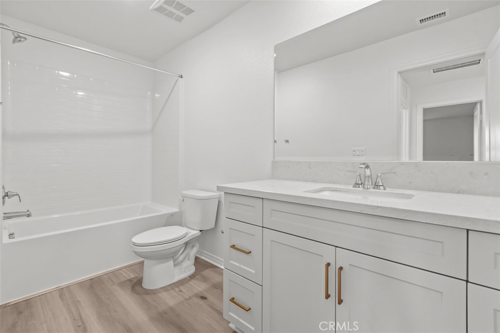 9667 Salamanca Street Riverside, CA 92508 - Photo 9 of 15 a bathroom with a sink toilet a bathtub and a shower