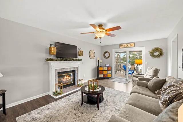 a living room with furniture a fireplace and a flat screen tv