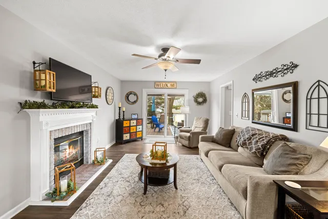 a living room with furniture a fireplace and a flat screen tv