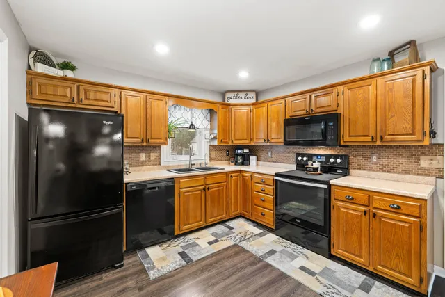 a kitchen with stainless steel appliances granite countertop a refrigerator stove microwave and sink