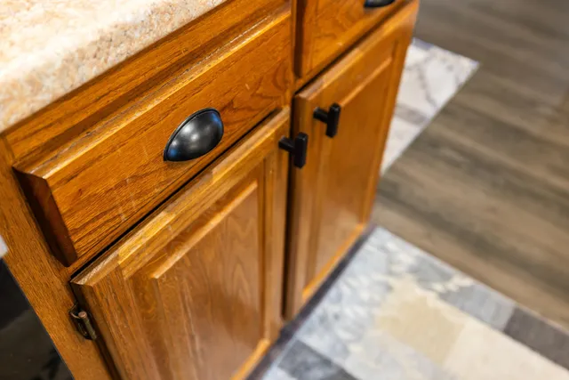 a dining room with wooden floor a chandelier a wooden table and chairs