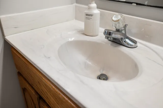 a bathroom with a sink and a mirror