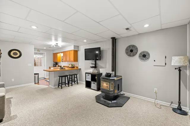 a view of a patio with table and chairs potted plants and floor to ceiling window