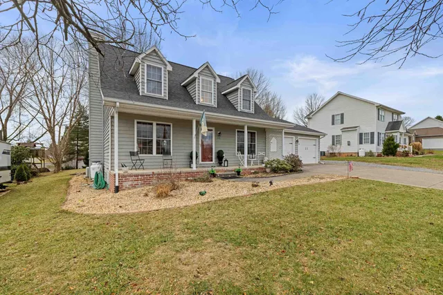 a view of a house with pool and a yard