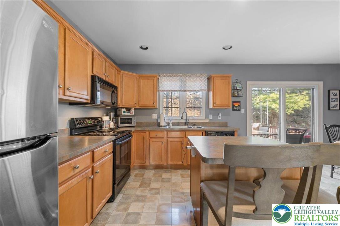 1409 Ravena Street Bethlehem, PA 18015 - Photo 12 of 40 a kitchen with stainless steel appliances granite countertop a stove a sink and a microwave