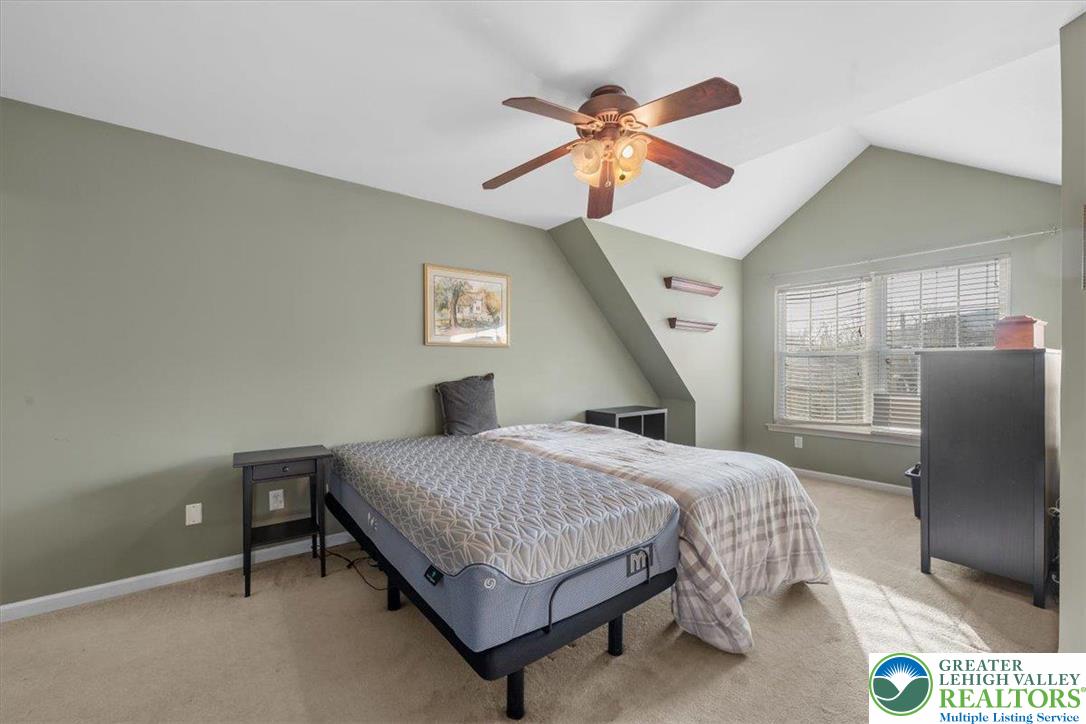 1409 Ravena Street Bethlehem, PA 18015 - Photo 17 of 40 a bedroom with a bed and a chandelier