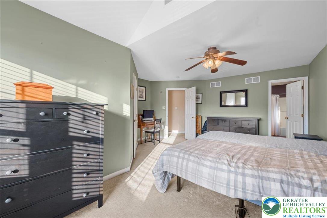 1409 Ravena Street Bethlehem, PA 18015 - Photo 18 of 40 a bedroom with a bed and a chandelier