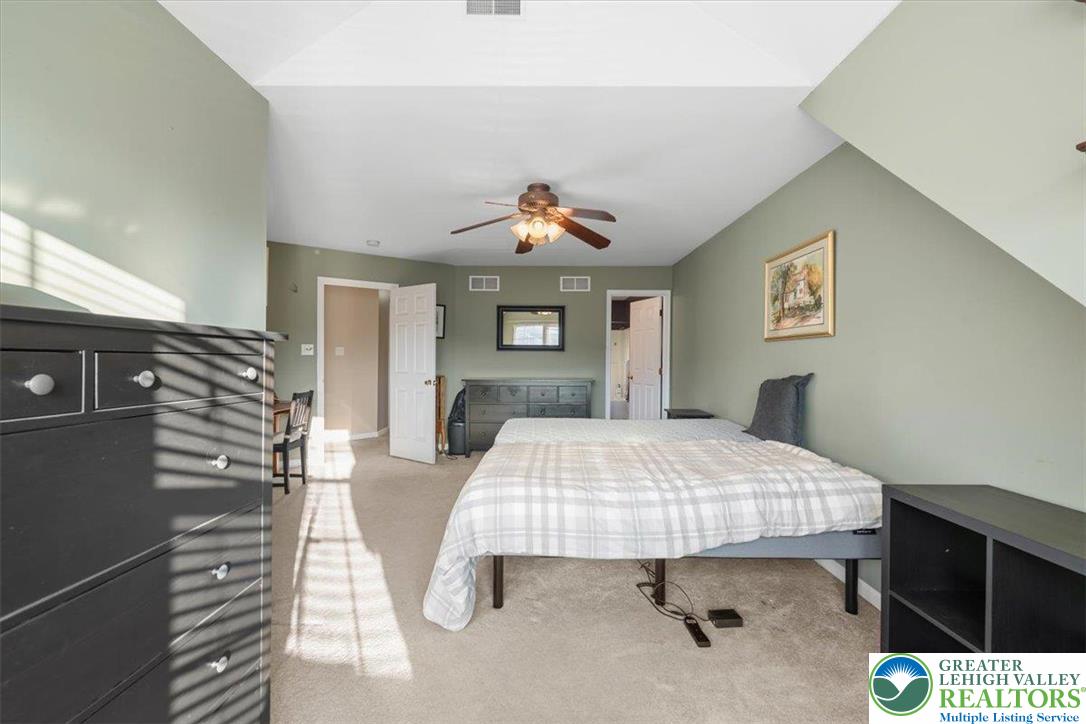 1409 Ravena Street Bethlehem, PA 18015 - Photo 19 of 40 a bed room with a bed and a chandelier