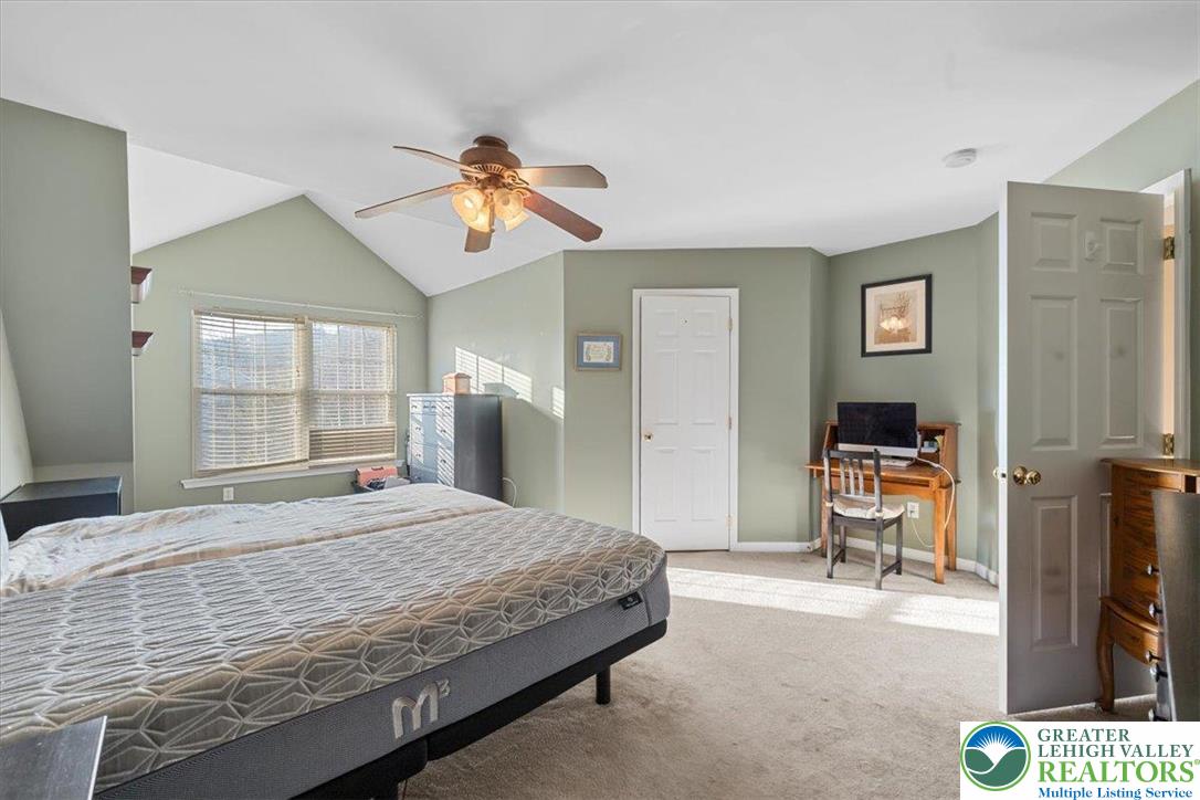 1409 Ravena Street Bethlehem, PA 18015 - Photo 20 of 40 a bedroom with a bed and a chandelier