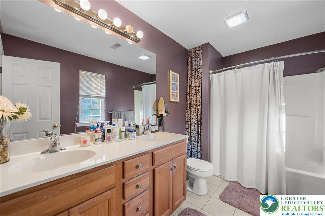1409 Ravena Street Bethlehem, PA 18015 - Photo 21 of 40 a bathroom with a double vanity sink mirror and toilet