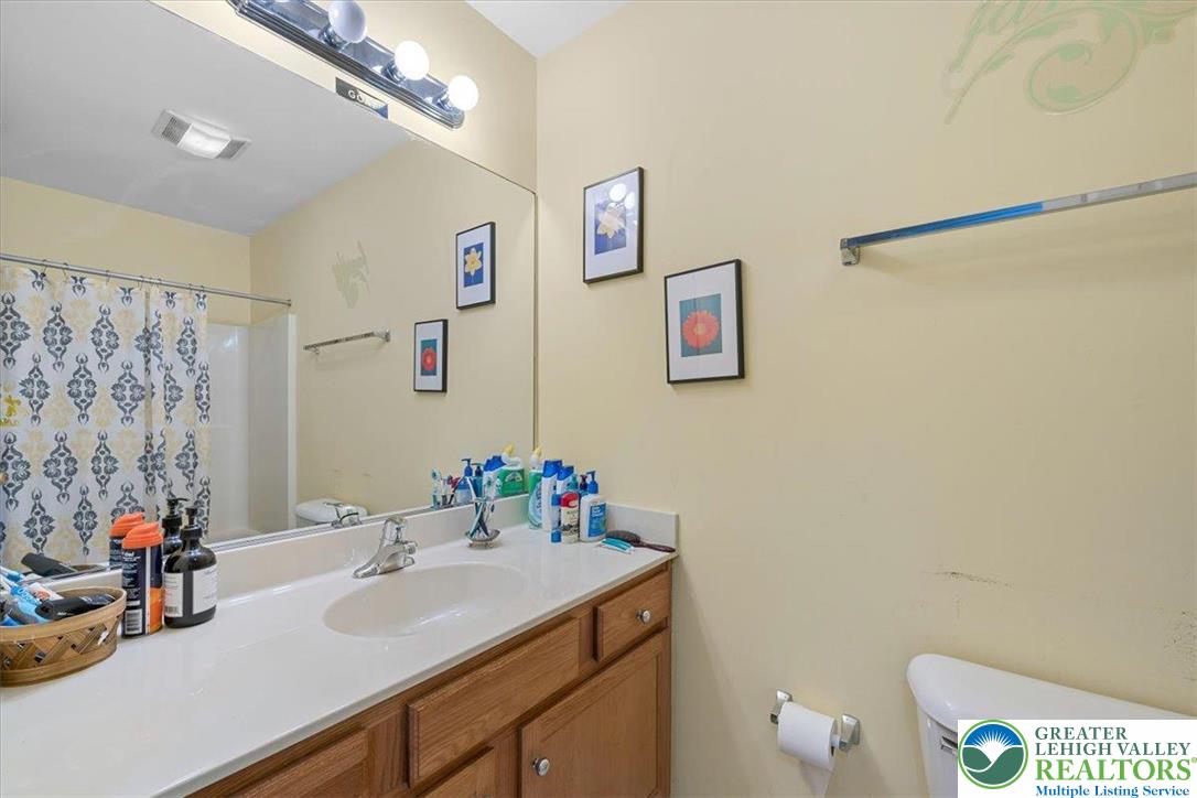 1409 Ravena Street Bethlehem, PA 18015 - Photo 29 of 40 a bathroom with a sink mirror and a toilet