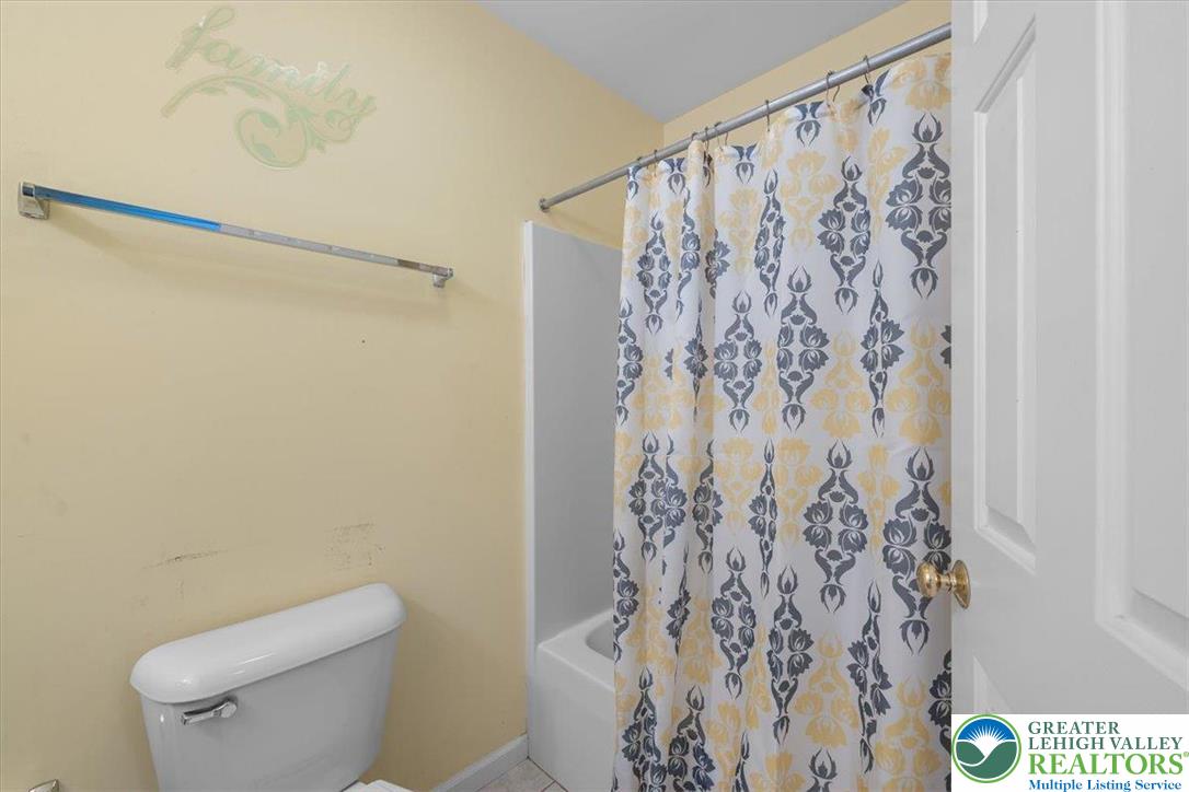 1409 Ravena Street Bethlehem, PA 18015 - Photo 30 of 40 a white toilet sitting next to a shower curtain